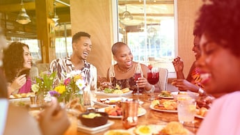 A group of 6 people eating brunch together in a restaurant