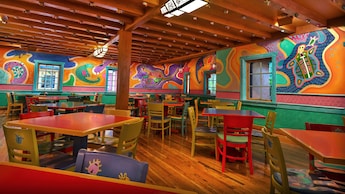 A large dining area furnished with tables and chairs in Pizzafari restaurant at Disney’s Animal Kingdom theme park