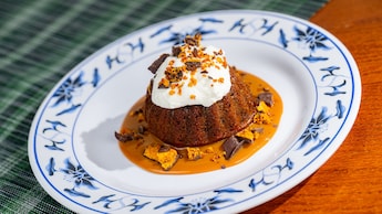 Sticky toffee pudding with whipped cream and toffee sauce