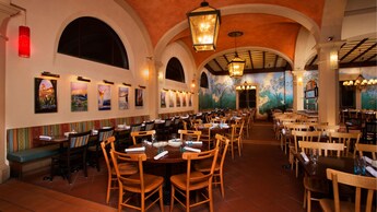 Dining area with tables and banquette seating and arched ceilings