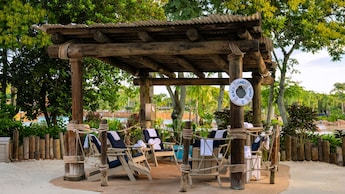 Beachcomber Shack 5, a shaded private cabana with lounge chairs at Disney's Typhoon Lagoon water park