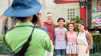 A Disney Cast Member taking a professional photo of a family