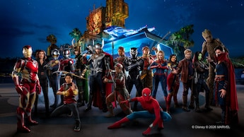 A group of Marvel characters standing in front of Avengers Headquarters