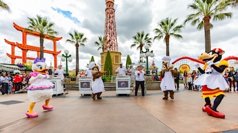 Daisy Duck, Clarabelle Cow, and Chip and Dale dancing in chefs' outfits at Paradise Gardens Park