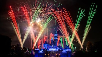 Fireworks bursting over an illuminated Sleeping Beauty Castle at Disneyland Park