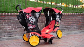 Two strollers decorated with images of Minnie Mouse.