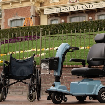 A wheelchair and a single-rider Electric Conveyance Vehicle.