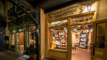 The facade of a New Orleans themed shop with the words 'Blue Skies & Sunshine Guaranteed' on the wall