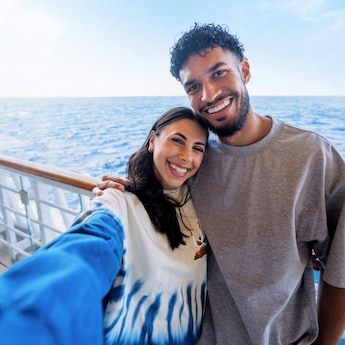 A woman and man pose for a selfie while on board a Disney ship A woman and man pose for a selfie while on board a Disney ship