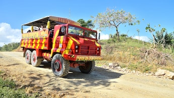 An open air mega truck filled with passengers