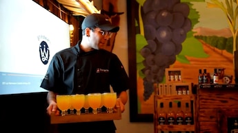 A server carrying a tray of sangria glasses