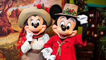 Minnie Mouse and Mickey Mouse wearing Christmas themed safari outfits at Adventurers Outpost in Disney’s Animal Kingdom theme park