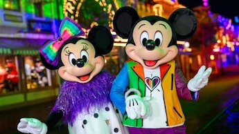 Mickey Mouse and Minnie Mouse dressed in colorful attire during Disneyland After Dark: Pride Nite at the Disneyland Resort.