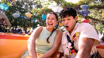 A boy and girl riding in a teacup on the Mad Tea Party at Disneyland Park