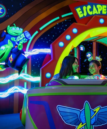 Guests smiling as they ride Buzz Lightyear's Space Ranger Spin at Magic Kingdom park