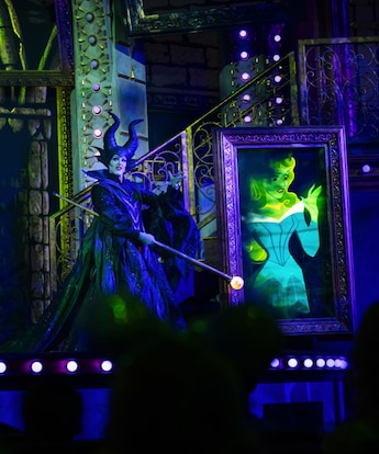 Maleficent on stage with an animated portrait of Aurora during Disney Villains, Unfairly Ever After at Disney’s Hollywood Studios