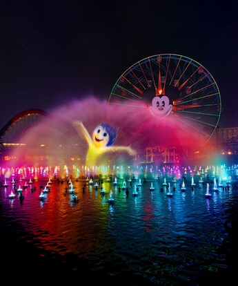 The character Joy projected on a wall of water during the World of Color Happiness nighttime spectacular