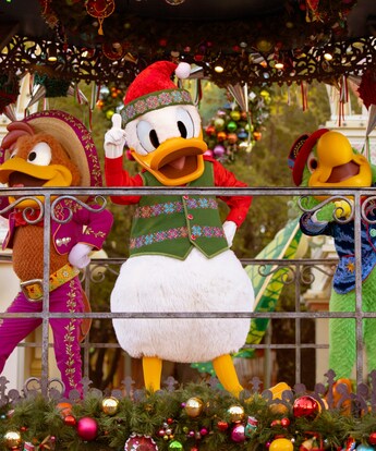 Donald Duck, Panchito Pistoles and José Carioca, dressed in holiday attire on a parade float during the Disney Viva Navidad celebration at Disney California Adventure Park