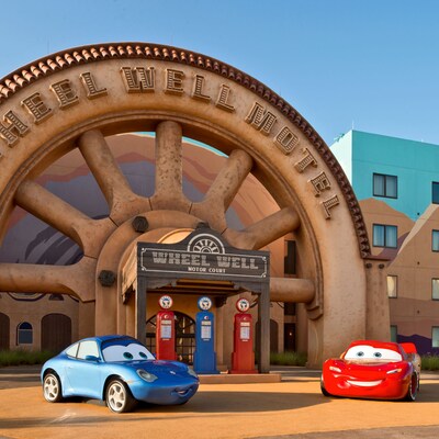 Lightning Mcqueen and Sally Carrera cars parked outside cars family suites