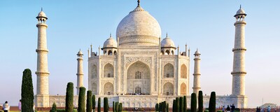 The Taj Mahal with large dome, arched windows and surrounding towers in Agra, India