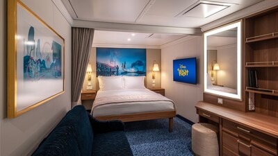 A Disney Wish Inside Stateroom with a bed, sofa, desk, mirror, TV, 2 nightstands and artwork inspired by Cinderella
