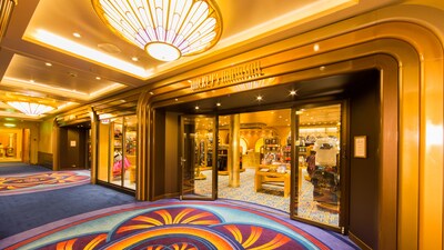 Colorful carpet and a shiny, golden doorway outside Mickeys Mainsail, a store