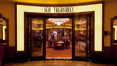 A lit art deco sign identifies Sea Treasures, a store