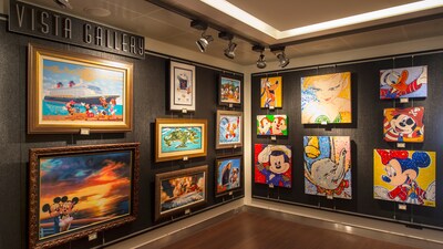 A variety of Disney artwork lines the walls of a gallery