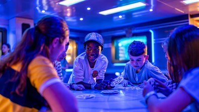 Young kids in a lounge playing a card game