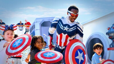 A group of children holding shields around Captain America Sam Wilson