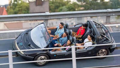 A family of 5 Guests smiling as they ride Test Track at Epcot