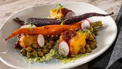 A plate of chickpea panisse topped with roasted chickpeas and carrots