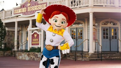 Jessie standing in front of The Diamond Horseshoe in Magic Kingdom park