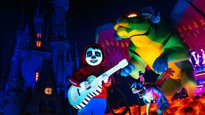 Miguel from Coco performing on a parade float near Cinderella Castle at Magic Kingdom park