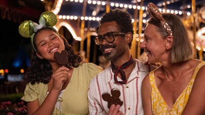 3 Guests with Mickey Cookie Pops near the Prince Charming Regal Carrousel 