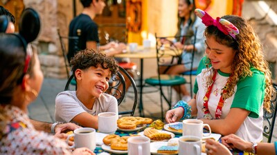 A family eats a meal outdoors at the Morocco Pavilion in the World Showcase at EPCOT