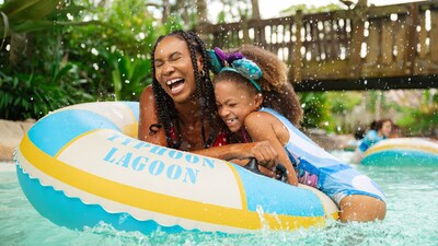 A laughing mother and her young daughter on an inner tube in Castaway Creek at Disney’s Typhoon Lagoon water park
