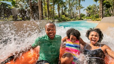 A family laughing while riding Miss Adventure Falls