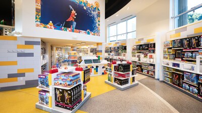 The Lego Store interior with product displays and a large Sorcerer Mickey mural