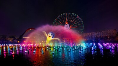 A World of Color One show featuring illuminated water fountains and a projection of Joy from ′Inside Out′ on a mist screen near Pixar Pal A Round Swinging at Disney California Adventure Park