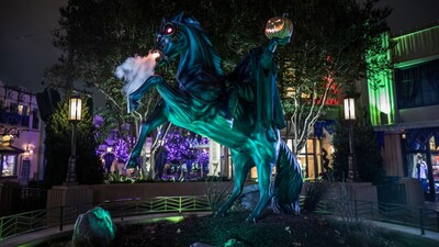 With lights and smoke effects, a 10 foot tall statue of the Headless Horseman holding his jack O lantern head to the sky.