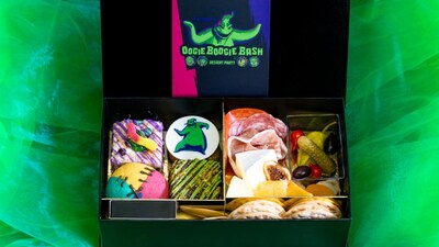 Halloween themed treats in a box labeled, ‘Oogie Boogie Bash Dessert Party’