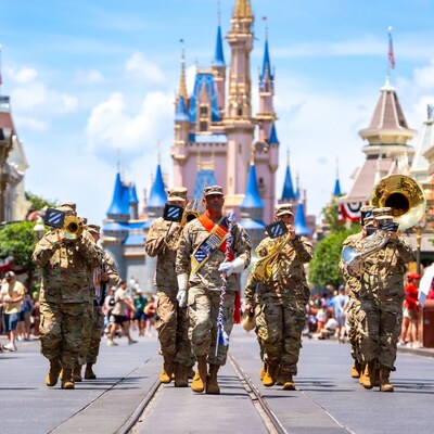 US military service members playing instruments as they march down Main Street, USA