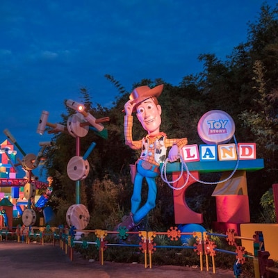 The entrance to Toy Story Land, featuring a giant Woody figure and oversized toys