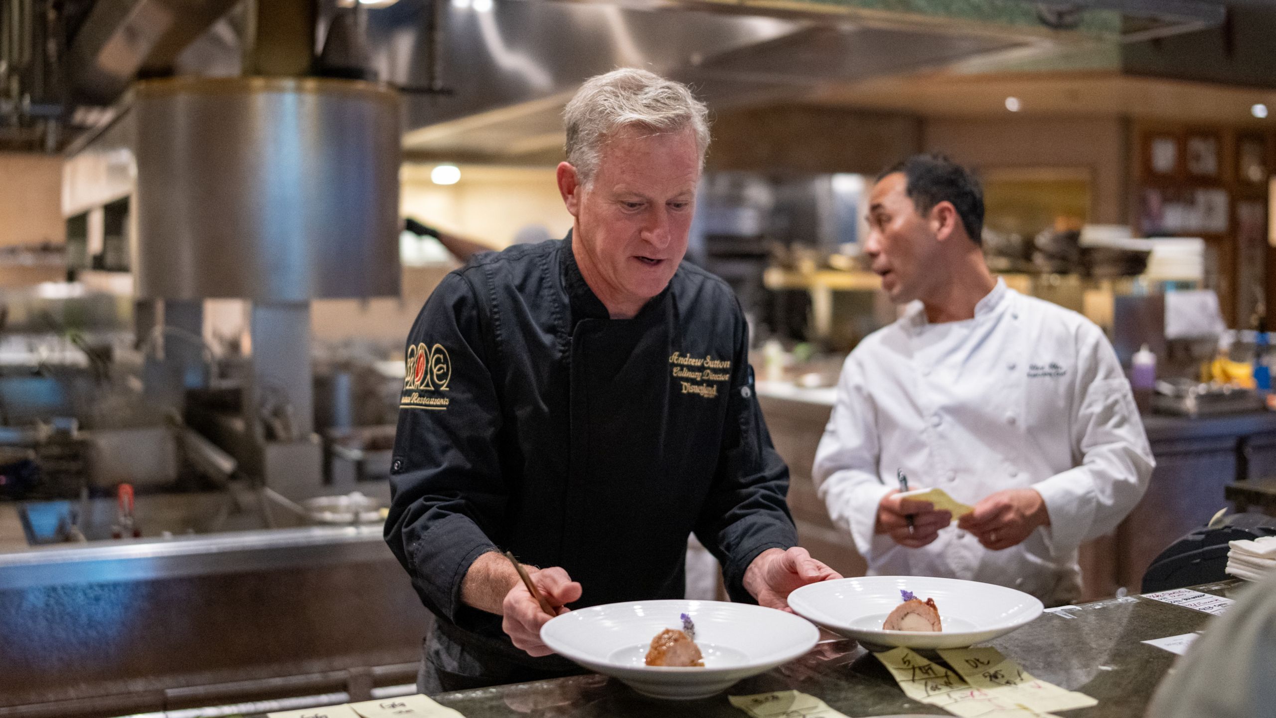 Chef Andrew Sutton working on 2 dishes near chef Clint Chin at Napa Rose kitchen 