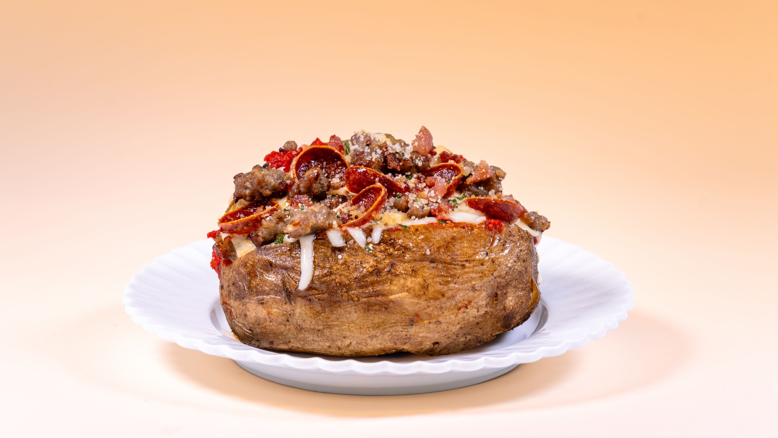 A baked potato loaded with pepperoni, sausage and melted cheese, available during Bluey's Best Day Ever