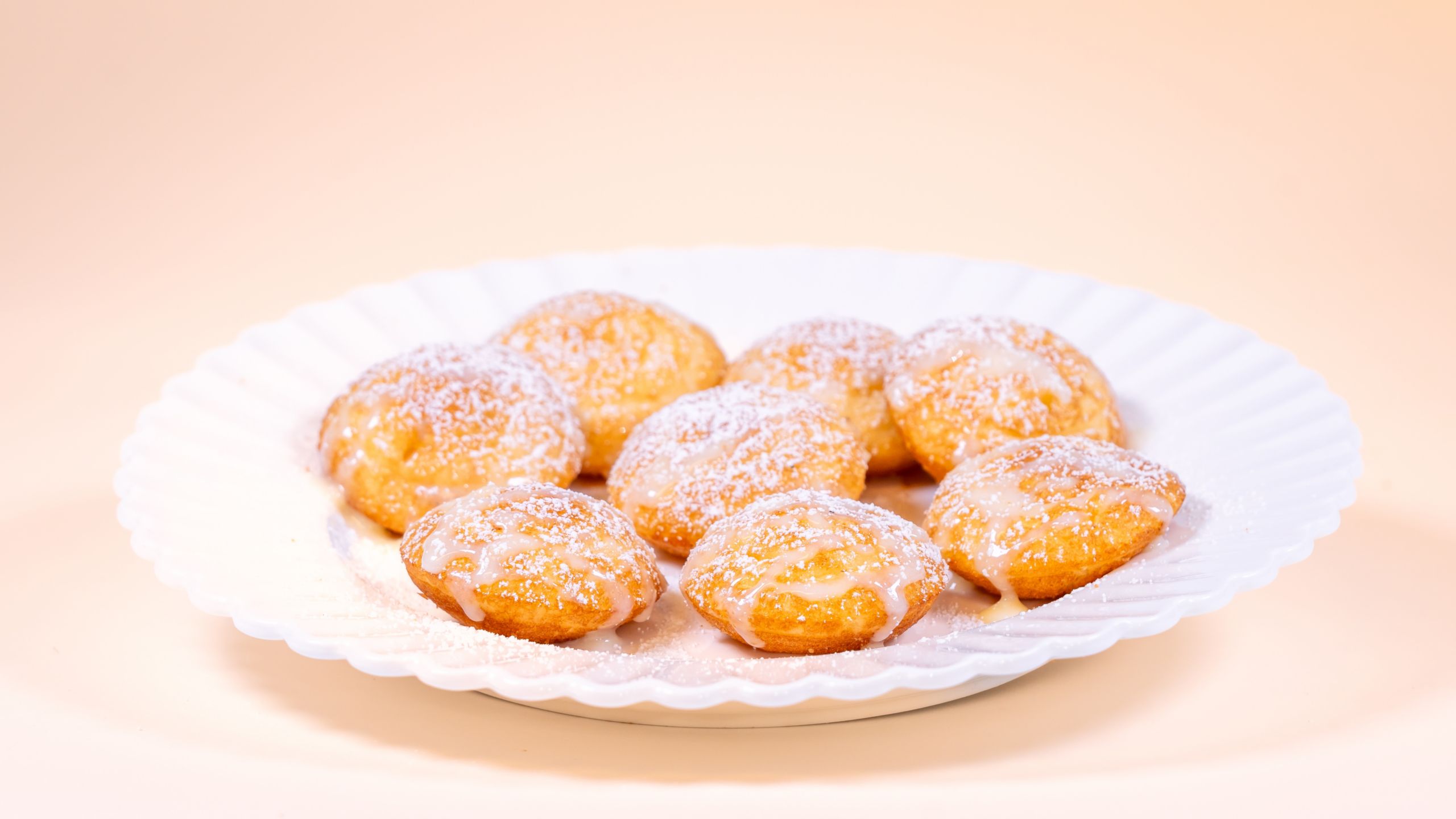 Powdered sugar dusted pastry bites with glaze, available during Bluey's Best Day Ever