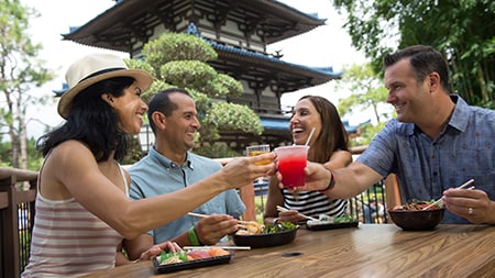Attendees enjoying food and drinks by the Japan Pavilion in Epcot