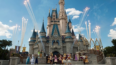Disney Characters gathered in front of Cinderella Castle while fireworks burst in the sky