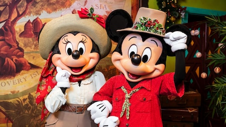 Minnie Mouse and Mickey Mouse wearing Christmas themed safari outfits at Adventurers Outpost in Disney’s Animal Kingdom theme park